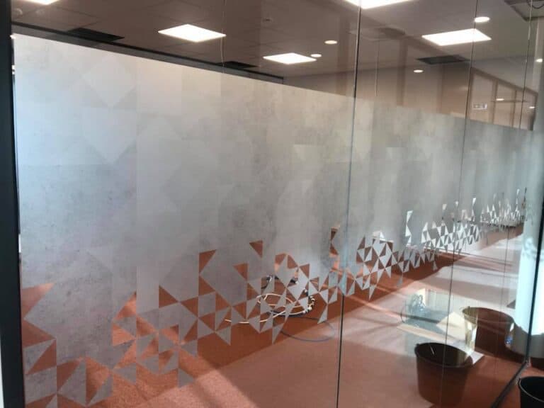 Office decor with inspirational quotes and brand colours on glass walls