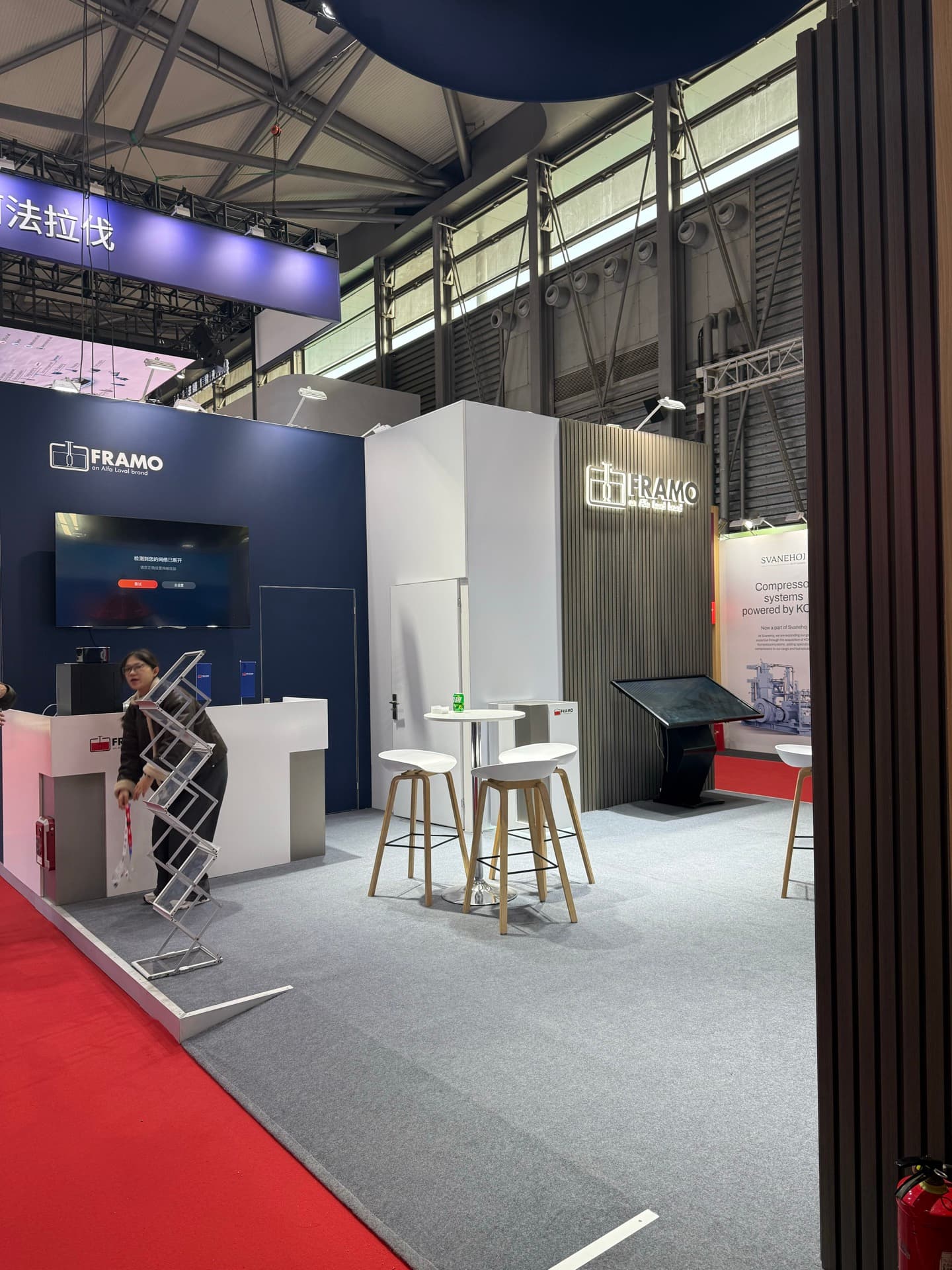 Framo exhibition stand at Marintec China 2025 in Shanghai with dark navy blue walls and illuminated Framo logo
